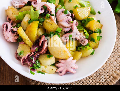 Potato salad with pickled octopus and green onions. Stock Photo