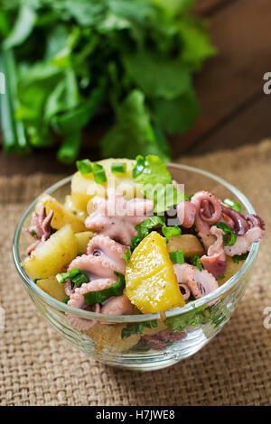 Potato salad with pickled octopus and green onions Stock Photo