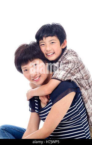 Happiness of Asian family with mom and son and daughter hug and kissing