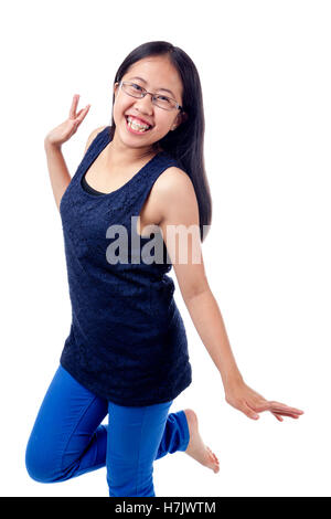 Cute Asian girl in braces striking a confident pose, isolated on white. Stock Photo