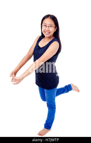 Cute Asian girl in braces striking a confident pose, isolated on white. Stock Photo