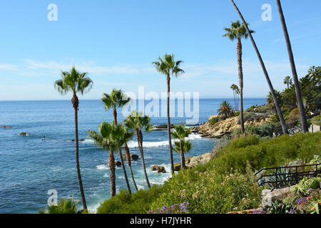 The Coastline at Laguna Beach, California, from Heisler Park with Catalina Island in the background. Paddle boarders and surfers Stock Photo