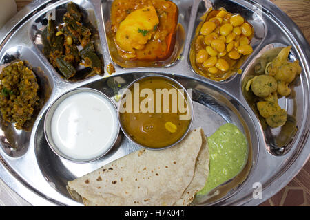 Close-up of Indian Vegeterian Thali with assorted curries in small bowls served in stainless steel plate Stock Photo