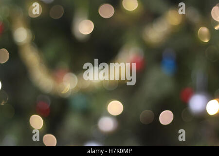 Defocussed Christmas background - Christmas tree, bokeh lights and baubles. Stock Photo