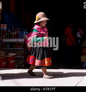 Peruvian girl dressed in colourful traditional handmade outfit. October 19, 2012 - Ollantaytambo, Peru Stock Photo