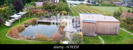 Ecological swimming pool and sauna complex. Plants are used to keep the water clean Photographed in Austria Stock Photo