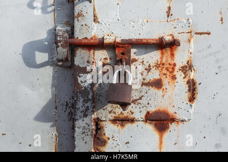 View of the padlock on the rusted gate Stock Photo