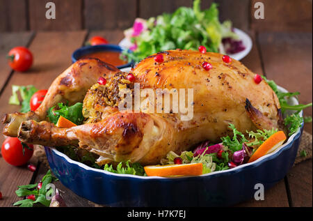Baked chicken stuffed with rice for Christmas dinner on a festive table. Stock Photo
