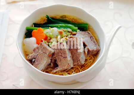 Chinese beef noodle soup on white table Stock Photo