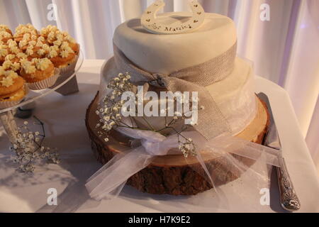 Just married horseshoe on the top of a wedding cake log stand Stock Photo