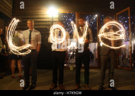 Love written with sparklers at a wedding Stock Photo