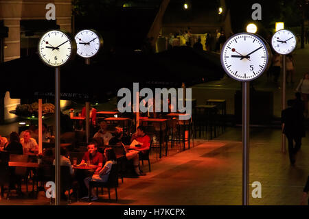 London, UK - August 30, 2016 - People dining outdoors at night in Canary Wharf Stock Photo