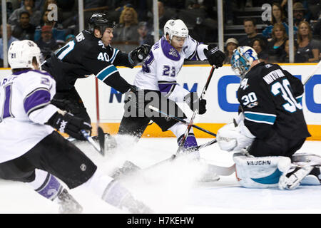 November 15, 2010; San Jose, CA, USA;  Los Angeles Kings right wing Dustin Brown (23) shoots in front of San Jose Sharks goalie Antero Niittymaki (30) and past defenseman Kent Huskins (40) during the first period at HP Pavilion. Right wing Scott Parse (left) scored on the deflection. Stock Photo