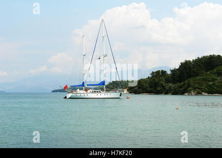 Nidri, GREECE, May 11, 2013: Landscape with green island, mountains and yacht in Ionian sea, Greece. Stock Photo