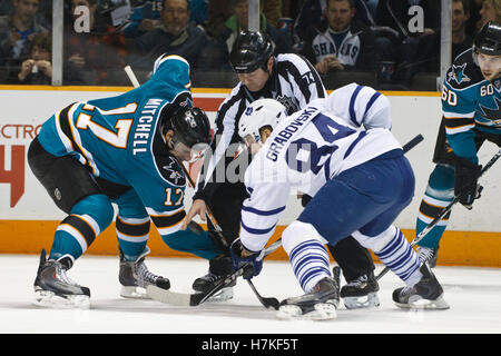 January 11, 2011; San Jose, CA, USA; NHL linesman Lonnie Cameron (74) drops the puck to San Jose Sharks center Torrey Mitchell (17) and Toronto Maple Leafs center Mikhail Grabovski (84) on a face off during the first period at HP Pavilion. Stock Photo
