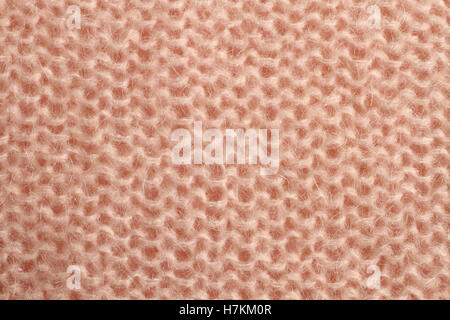 Light pink knitted wool fabric texture. Macro. Stock Photo