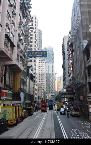 Hong Kong, China - Oct 29, 2016. Road traffic, double tram and Skyscrapers on Hong Kong Island. Stock Photo