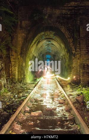 Helensburgh, Australia - 4th November 2016: Helensburgh tunnel near the old Helensburgh train station. This tunnel built between 1884 and 1886 is said to be haunted by the coal miner Robert Hales who passed away on the 13th of June 1895 after being struck by a passing steam train. Some say his ghost can be seen running from the darkness as trying to flee potential trains. - Helensburgh, New South Wales, Australia Stock Photo