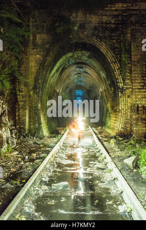 Helensburgh, Australia - 4th November 2016: Helensburgh tunnel near the old Helensburgh train station. This tunnel built between 1884 and 1886 is said to be haunted by the coal miner Robert Hales who passed away on the 13th of June 1895 after being struck by a passing steam train. Some say his ghost can be seen running from the darkness as trying to flee potential trains. - Helensburgh, New South Wales, Australia Stock Photo