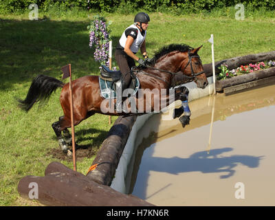 Rider on horse jumping over water during yearly cross country contest Bitsa, 2016, Moscow, Russia Stock Photo