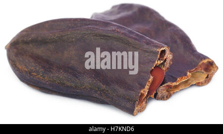 Edible carob fruits over white background Stock Photo