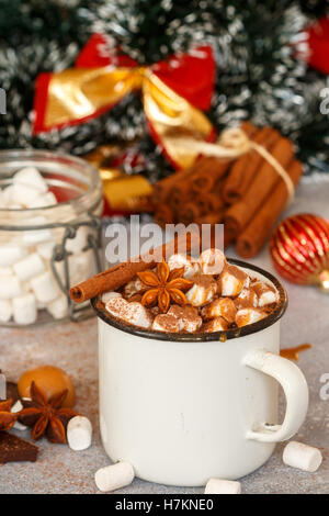 Hot chocolate with marshmallows, cinnamon and caramel sauce in a white mug. Selective focus Stock Photo