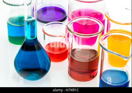 various beakers with different types of indicators in acids and basis, four colors of indicators in several solutions Stock Photo