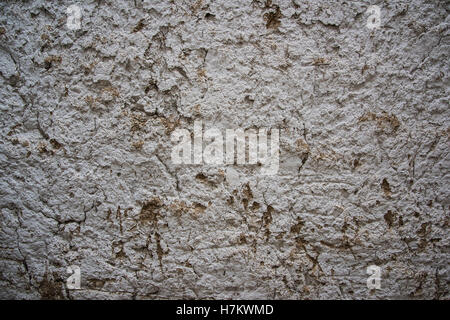 cracked clay wall of the straw house Stock Photo