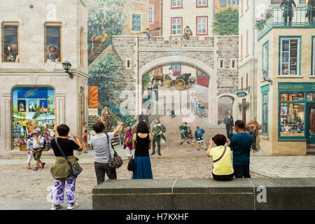 tourists of Asian extraction taking photographs in front of The Fresco for the People of Quebec, 'Quebec City', Quebec, Canada Stock Photo