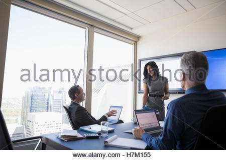 Business people talking in meeting in urban conference room