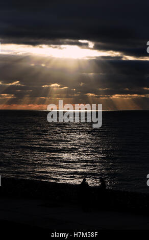 Brighton Sussex, UK. 6th Nov, 2016. Sunlight dramatically breaks through the clouds at sunset over Brighton after another beautiful Autumn day in the south of Britain Credit:  Simon Dack/Alamy Live News Stock Photo