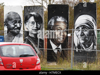 Portraits of famous personalities such as Mother Theresa (r-l), Nelson Mandela, Aung San Suu Kyi, Mahatma Gandhi and the Dalai Lama can be seen on concrete parts of the Berlin wall in Teltow, Germany, 07 Novmeber 2016. The painted sections of the wall are for sale. On 09 November, 27 years ago, the wall fell in Berlin. Photo: RALF HIRSCHBERGER/dpa Stock Photo