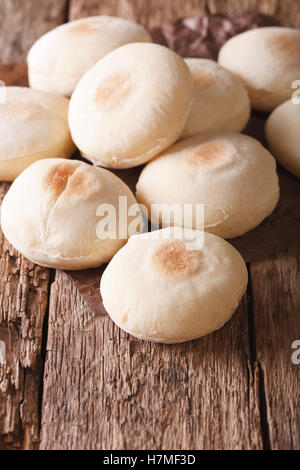 Moroccan small pita batbout close-up on the table. Vertical Stock Photo