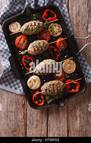 kebab with grilled vegetables on the grill pan on the table. vertical view from above Stock Photo