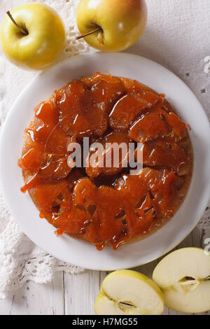 Apple pie Tarte Tatin with caramel close-up on a plate. vertical view from above Stock Photo