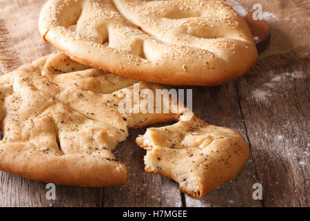 Fougasse bread with sesame seeds and herbs closeup on the table. horizontal Stock Photo