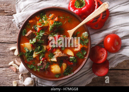 Traditional Hungarian goulash soup bogracs close-up in a bowl on the table. horizontal view from above Stock Photo