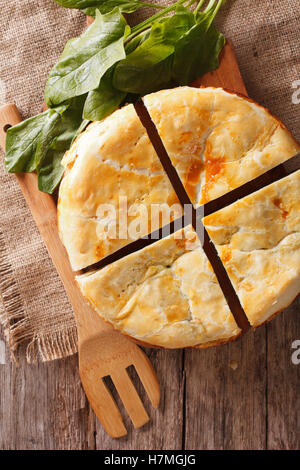 Tasty sliced Greek spanakopita pie close-up on the table. vertical view from above Stock Photo