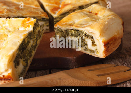 Freshly baked Greek pie with spinach on the table macro. horizontal Stock Photo