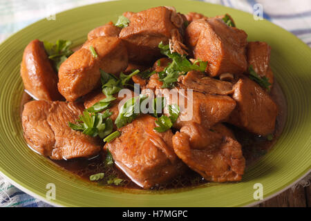 Adobo Chicken with herbs close-up on a plate on the table. horizontal Stock Photo