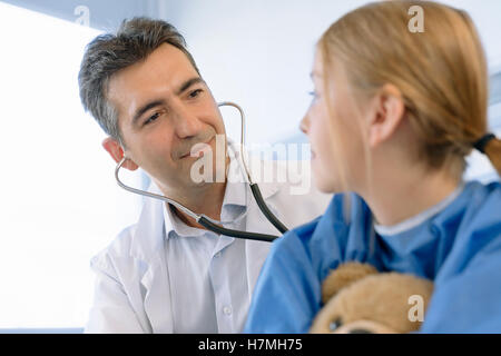Doctor examining girl patient in hospital Stock Photo