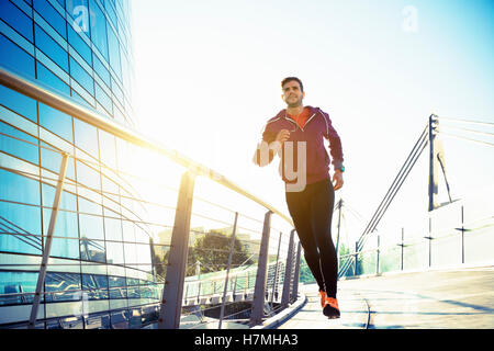 athlete with earphones running in the city Stock Photo