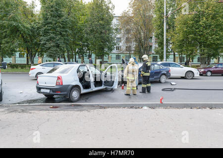 Employees of the Ministry of Emergency Situations in place of traffic accident (collision of two cars) Stock Photo