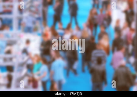 Abstract blurred people attending event in exhibition hall, press conference or celebration party, visitors of indoor fair Stock Photo