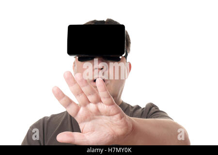 man wearing VR virtual reality headset reaching out Stock Photo
