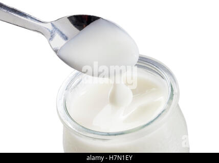 yogurt with spoon isolated on white background Stock Photo