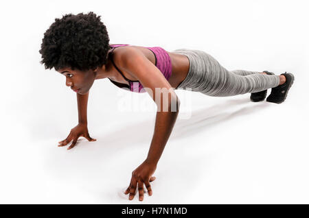 fit black woman doing push-ups over white background Stock Photo
