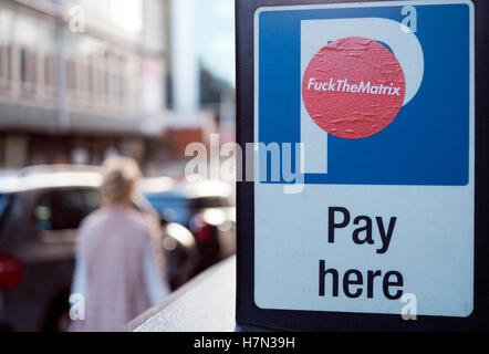 Pay Here; Abusive sticker on car park ticket machine on Liverpool city street, Merseyside UK which makes reference to Police Matrix Crime squad, Stock Photo