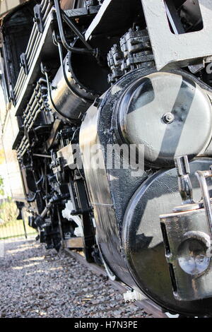 close up of vintage locomotive resting on train tracks Stock Photo