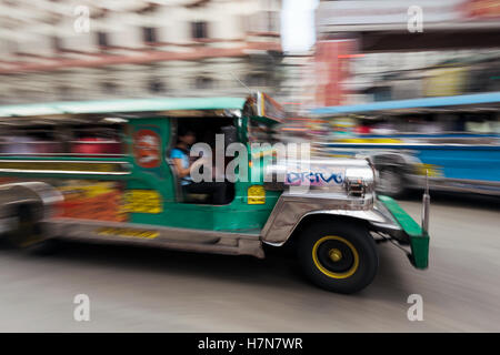 Manila, Philippines - February 20, 2016: Motion blured speeding Jeepney in Manila - Philippines. Stock Photo